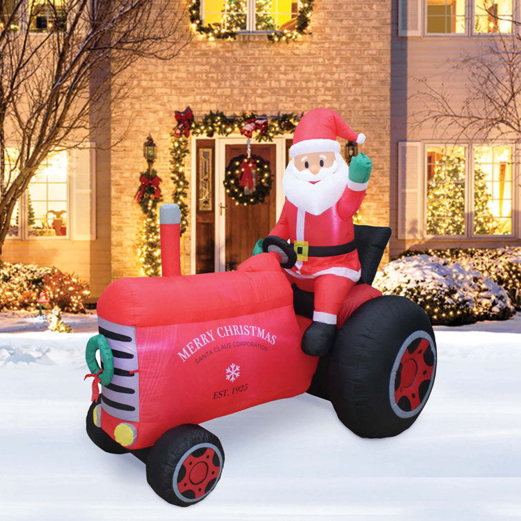 The Holiday Aisle® Santa on Tractor Inflatable Wayfair